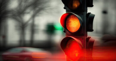 red-traffic-light-blurred-moving-with-passing-cars