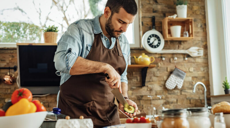 Young Man Preparing Healthy Food Peeling Avocado Kitchen