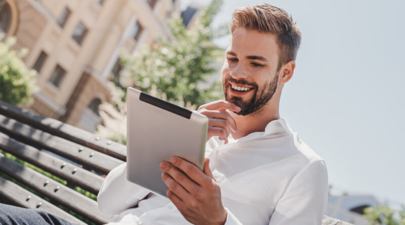 Social Life Young Smiling Man Sitting Bench Park Holding His Tablet