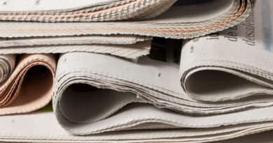 high-angle-old-texture-newspapers-stack