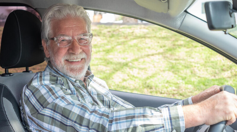 Handsome Senior Man With Glasses Sitting Inside His Car Smiles While Looking Into Camera Smiling Bearded Elderly Grandfather With Hands Steering Wheel