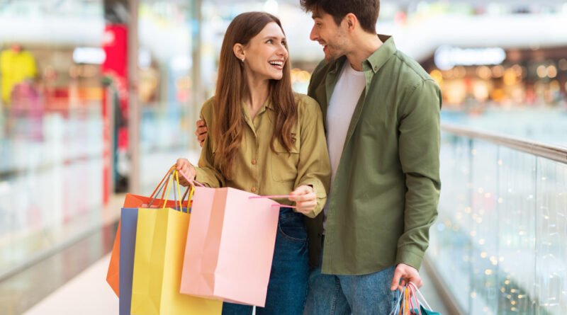 Joyful Couple Doing Shopping Holding Colorful Shopper Bags Mall