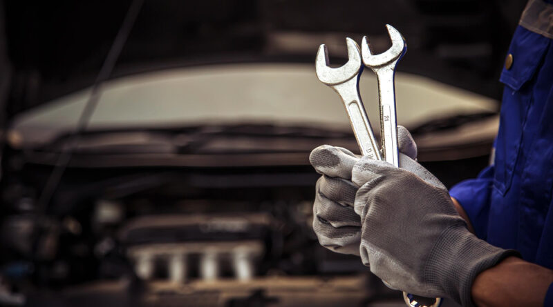 Closeup Hand Technician Holding Wrench Repairing Car