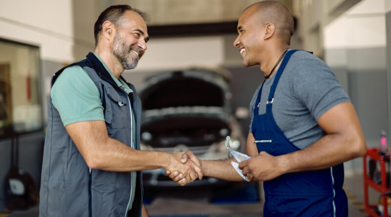 Happy Mechanic Greeting With His African American Coworker Auto Repair Shop
