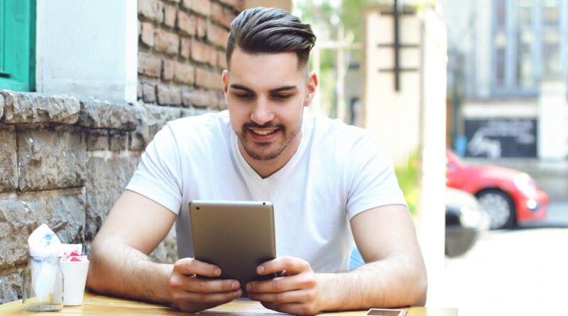 Young Man Coffee Shop Cafe Using Tablet