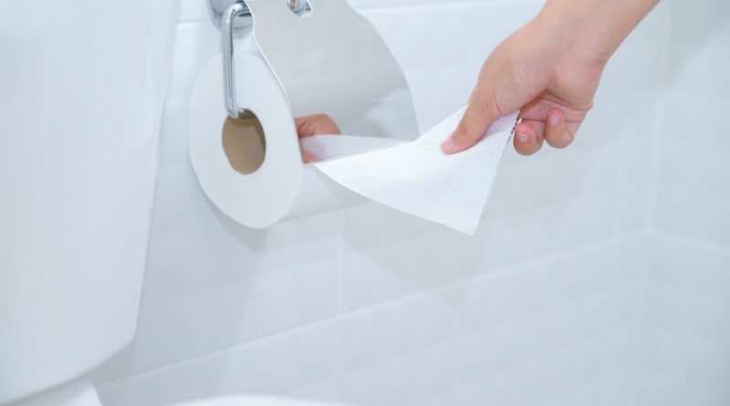 close-up-woman-hand-using-toilet-paper-white-clean-toilet-room
