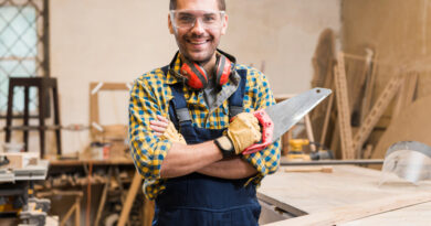 Portrait Smiling Male Carpenter Holding Handsaw Looking Camera