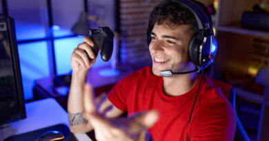 young-hispanic-man-streamer-playing-video-game-using-joystick-gaming-room