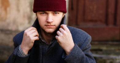 Man Fixes His Collar Posing Red Hat