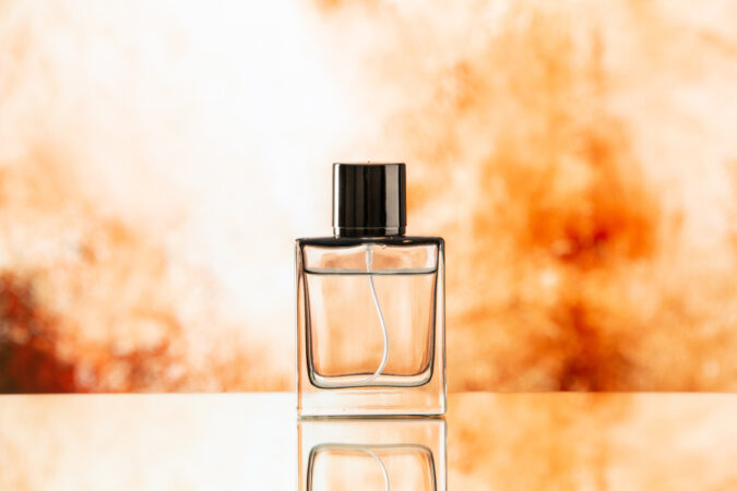 front-view-perfume-bottle-biege-blurred-background
