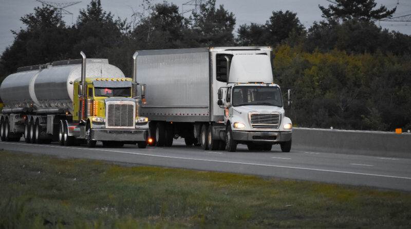 Trailer Trucks Driving Road Surrounded By Beautiful Green Trees