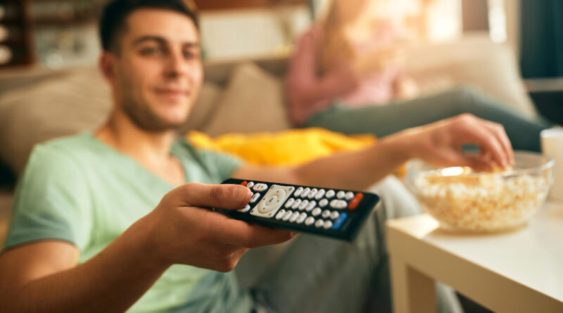 Closeup Man Changing Channels Tv While Eating Popcorn Home