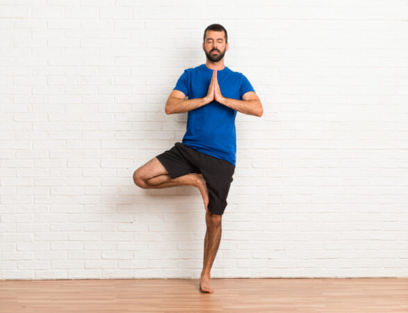 man-doing-yoga-exercises-indoors