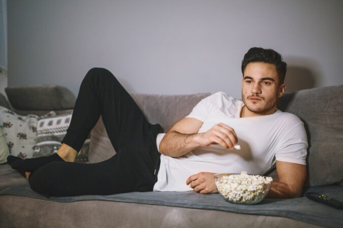 man-eating-popcorn-watching-tv
