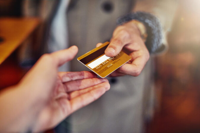 ill-put-it-my-card-cropped-shot-unrecognizable-young-man-handing-credit-card-shop