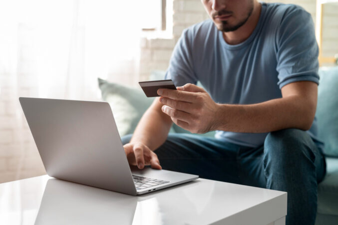 man-using-his-credit-card-play-online-order