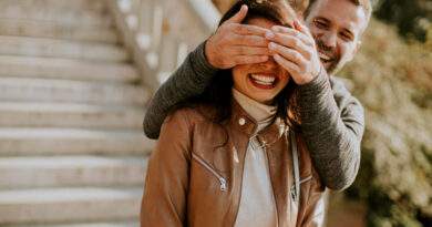 Young Man Covering Eyes His Girlfiend Park