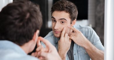 close-up-portrait-man-looking-himself-mirror-squeezing-his-pimples