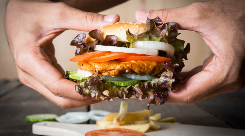 Man Holds Burger With Hands Potato Chip