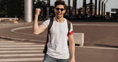 Man Rejoices Smiles Handsome Brunette Guy White Tee Sunglasses Holds Backpack Passport Near Airport