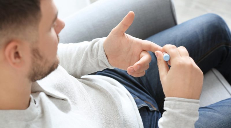 Diabetic Man Taking Blood Sample With Lancet Pen Home