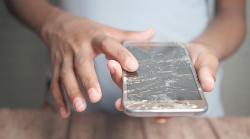 Close Up Man Hand Holding Broken Smart Phone