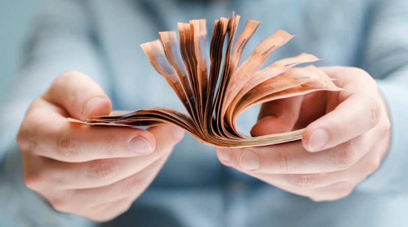 Front view person holding money