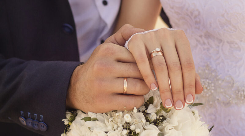 Closeup Shot Newlyweds Holding Hands Showing Wedding Rings