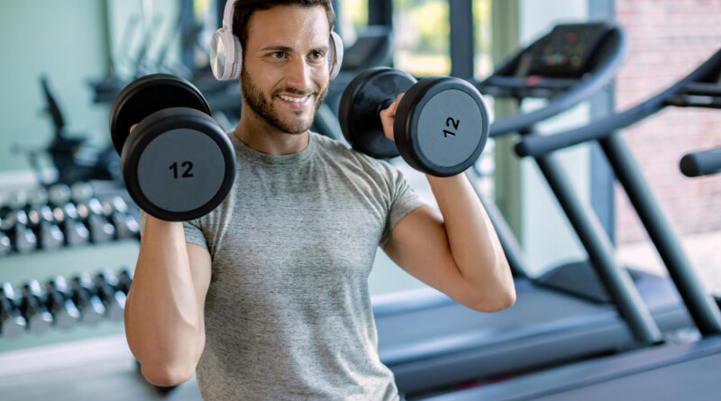 Young Happy Athletic Man Having Weight Training Health Club
