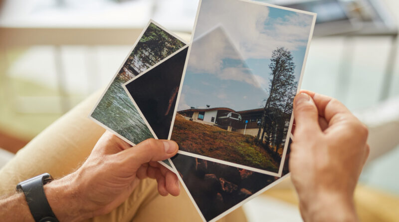 Close Up Man Holding Photos With Beautiful Landscapes His Hands