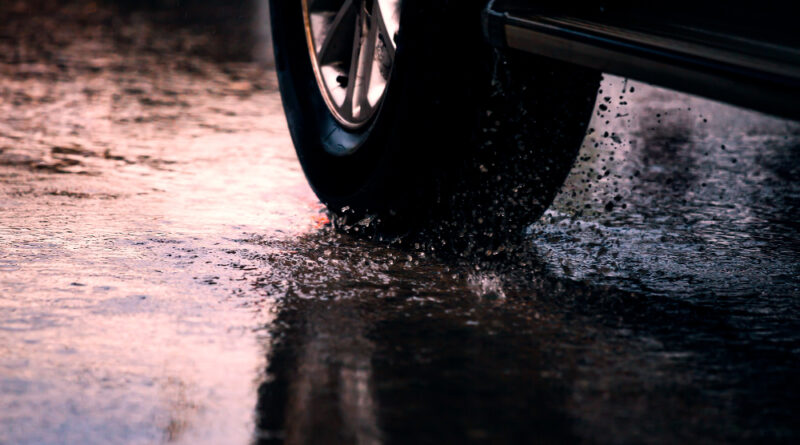 Motion Car Rain Big Puddle With Water Splashing From Wheels