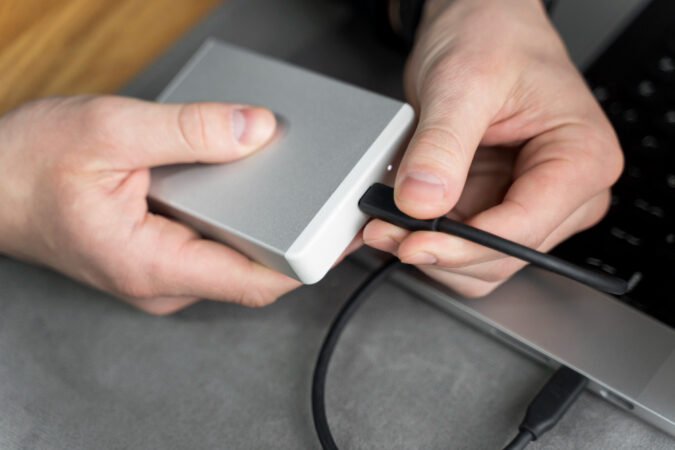 Close Up Hands Plugging Ssd Device