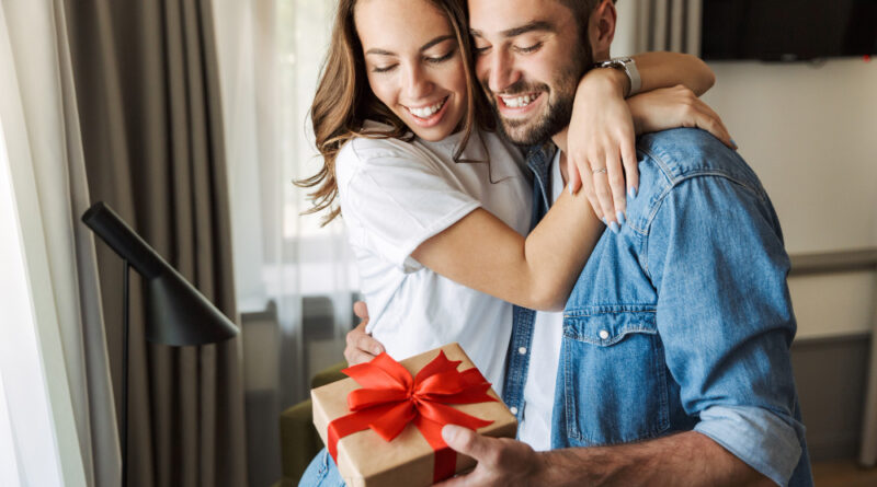 Beautiful Young Couple Love Home Celebrating With Gift Box Exchange Hugging