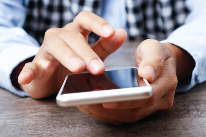 Closeup Woman Using Smartphone Table