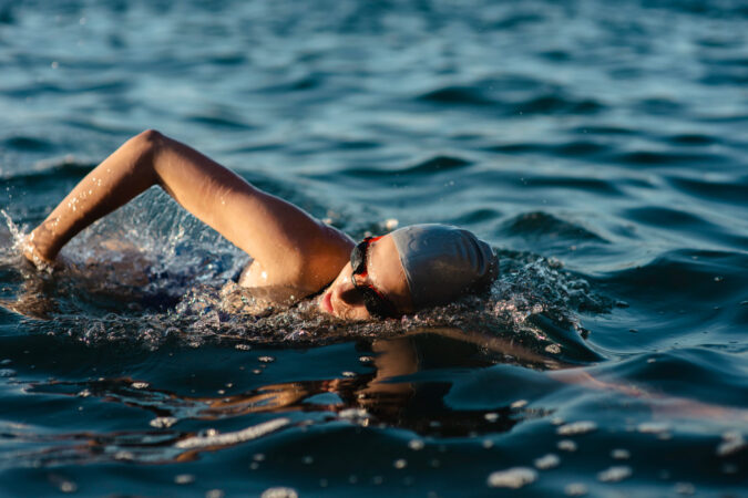 Side View Female Swimmer With Cap Goggles Swimming Water