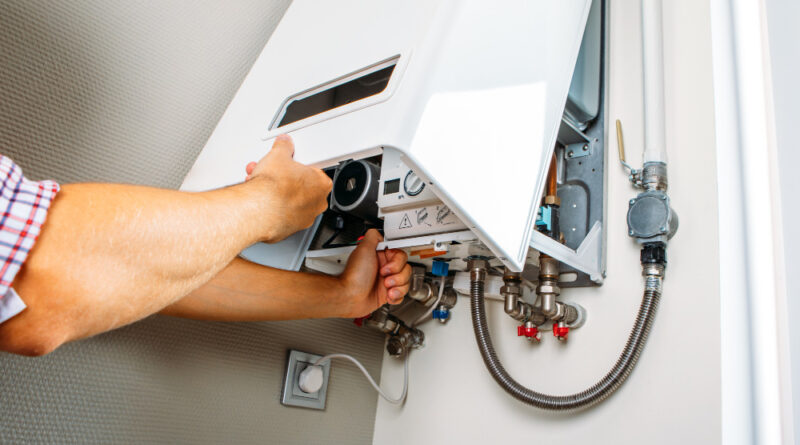 Plumber Attaches Trying Fix Problem With Residential Heating Equipment Repair Gas Boiler