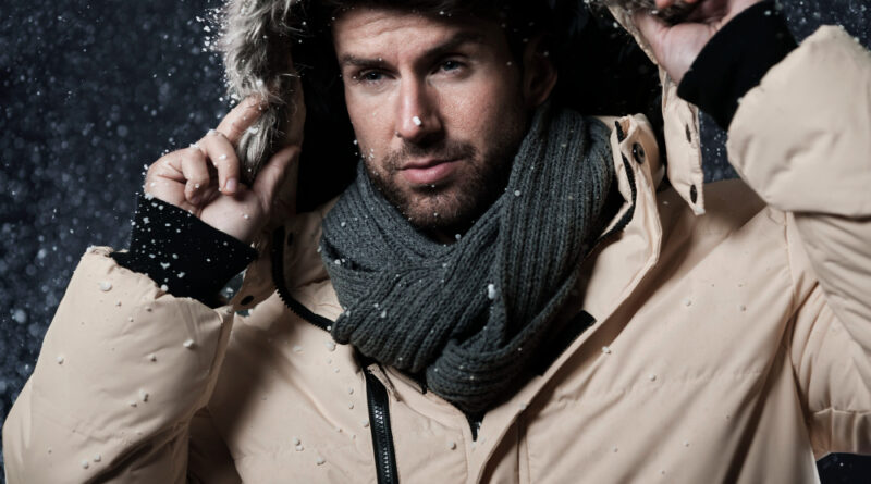 Man Wearing Winter Jacket While It S Snowing