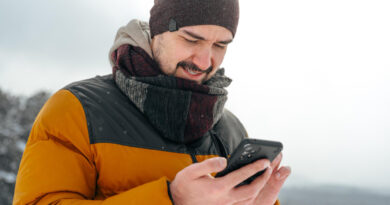 Young Man Snowy Winter Forest Using Cell Phone