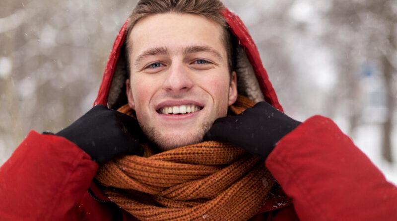 People Christmas Winter Season Concept Happy Smiling Man Jacket With Hood Adjusting Scarf Outdoors