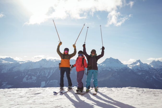 Celebrating Skiers Standing Snow Covered Mountain (1)