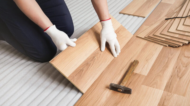 Man Installing Laminated Floor Detail Wooden Tile Being Fitted White Foam Base Layer