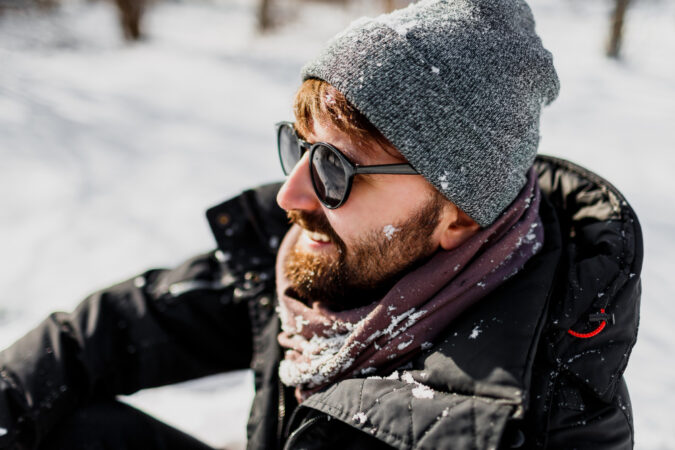 Winter Portrait Hipster Man With Beard Grey Hat Relaxing Sunny Park With Snowflakes Clothes