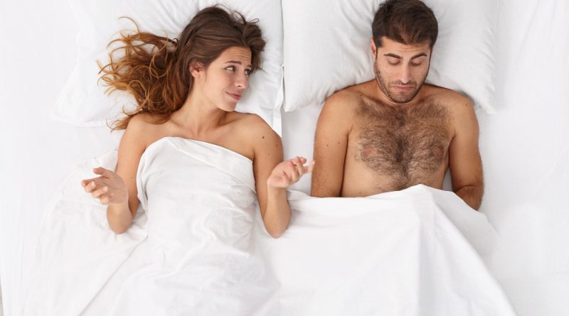 Disappointed Man Has Erectile Dysfunction During Sex His Woman Partner Lies Near White Blanket Puzzled With Husbands Impotence Spreads Hands Sideways Sexual Problems Men Health Concept