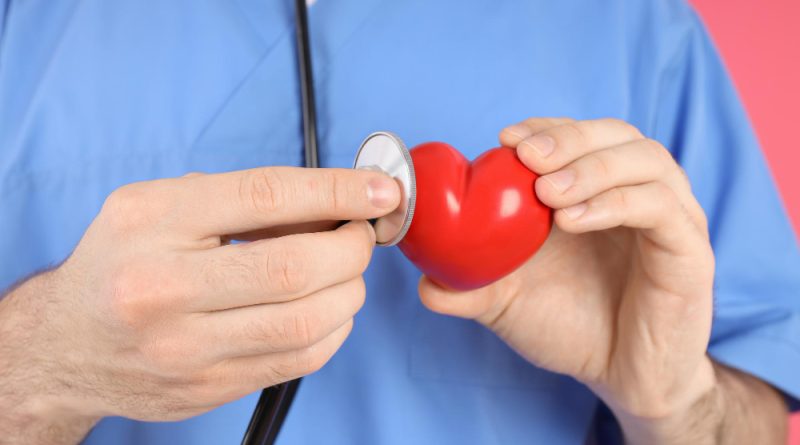 Nurse Man Holds Red Heart Close Up