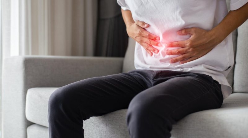 Young asian man wearing white tshirt touching his stomach because abdominal pain due gastritis stomach ulcer appendicitis gastrointestinal disease healthcare medical concept