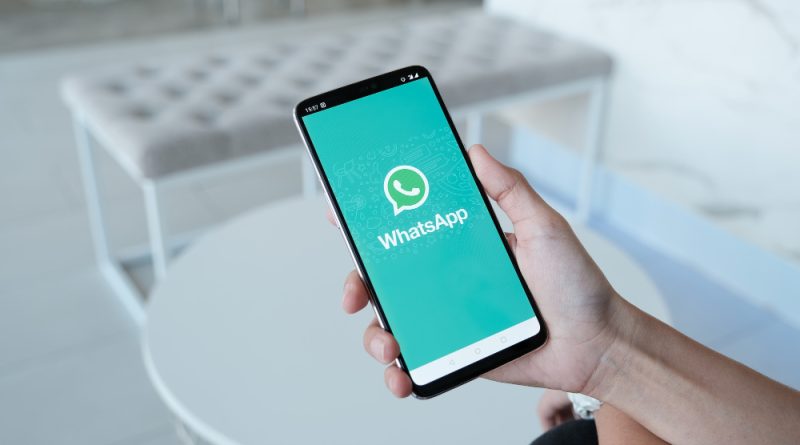 Woman holding smartphone with whatsapp screen