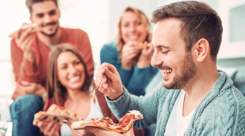 friends-pizza-four-young-cheerful-people-eating-pizza-home