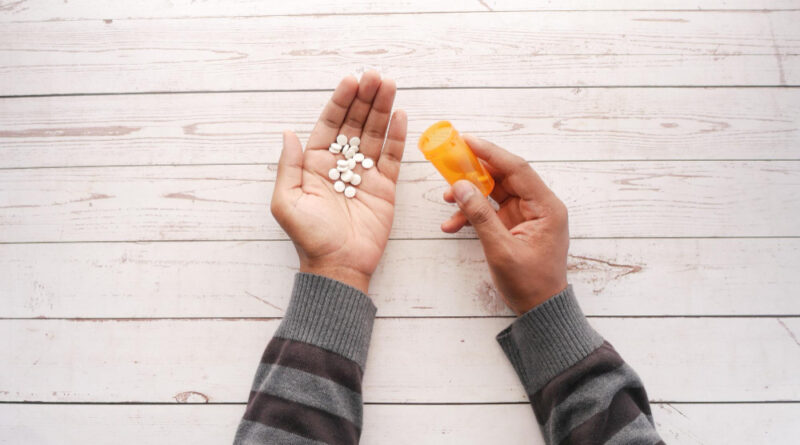 Top View Men Taking Medicine Table