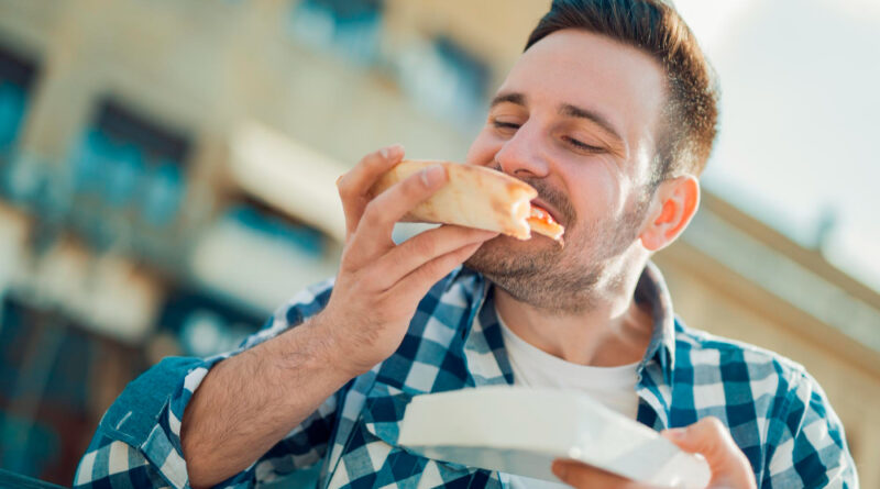 Handsome Young Man Eating Slice Pizza Outside Street