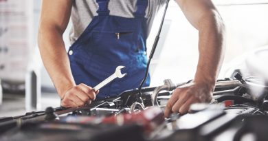 muscular-car-service-worker-repairing-vehicle
